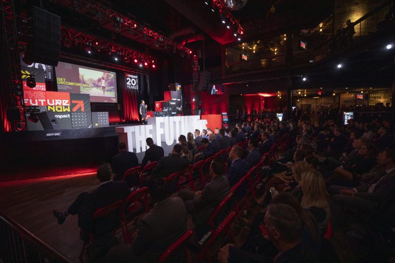 View of audience and stage at Impact company event.