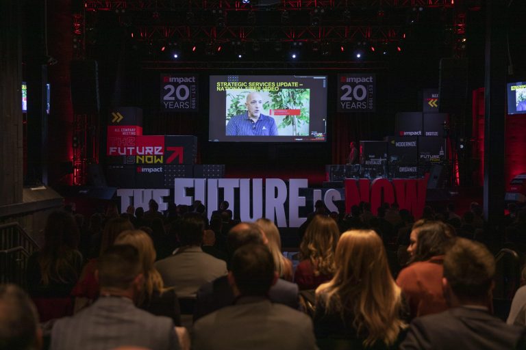 Video presentation on stage at Impact company event.